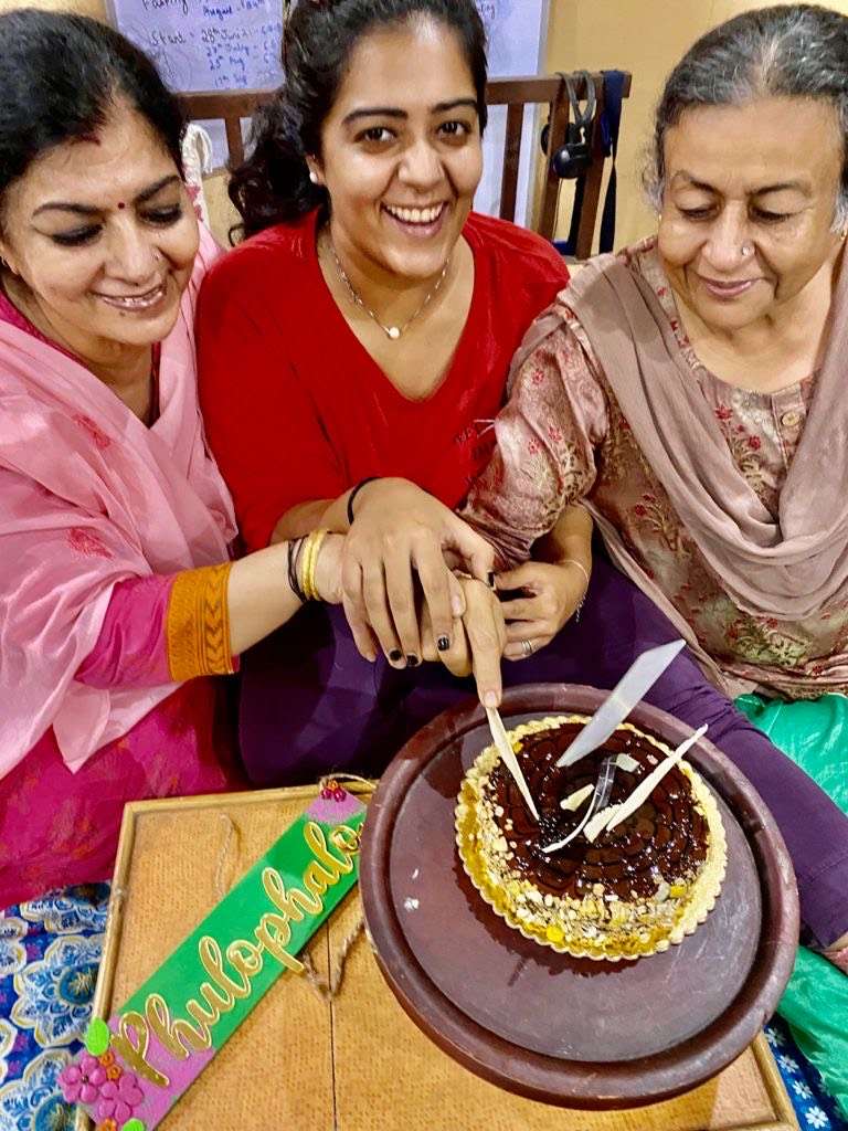 the women of Phulo Phalo cutting a cake to celebrate the business. Story by The Winged Women