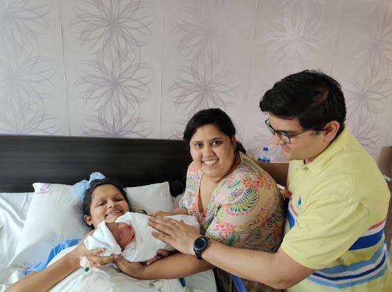 Shilpa's successful IVF journey. The picture shows her posing with her newly born baby, husband and her baby's surrogate mom Lucky 